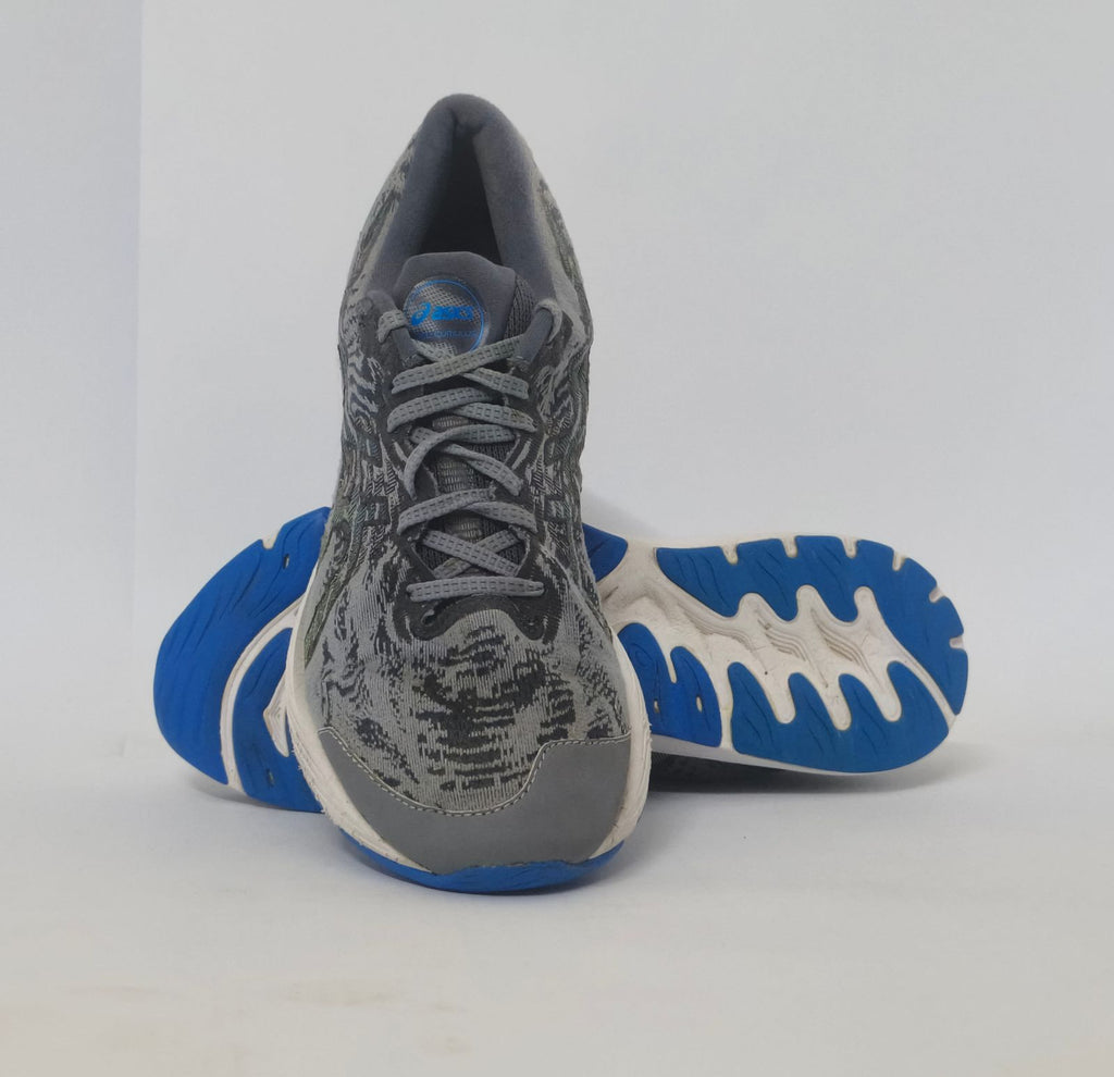 pair of grey ASICS Gel-Kayano running shoes featuring a patterned upper and a blue and white outsole.