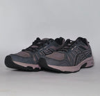 charcoal and lavender Asics GEL-Venture 7 trail running shoe featuring a rugged outsole and signature Asics stripes.