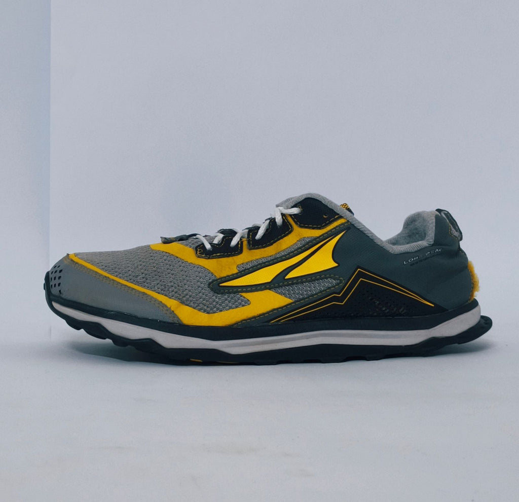 Grey and yellow athletic sneakers with breathable mesh upper and cushioned sole for running and casual wear