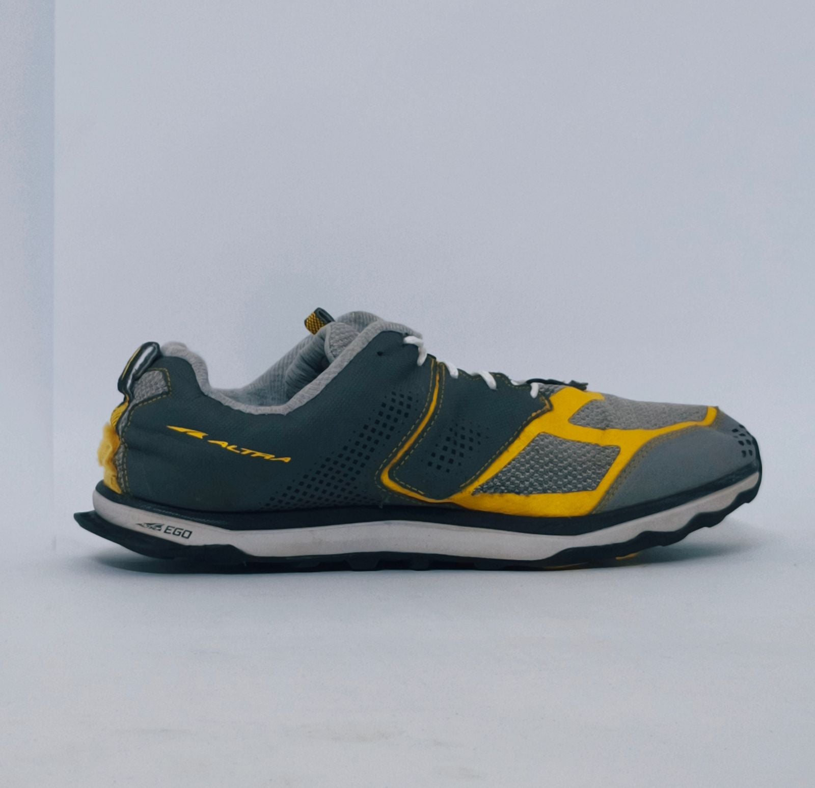 Grey and yellow athletic sneakers with breathable mesh upper and cushioned sole for running and casual wear