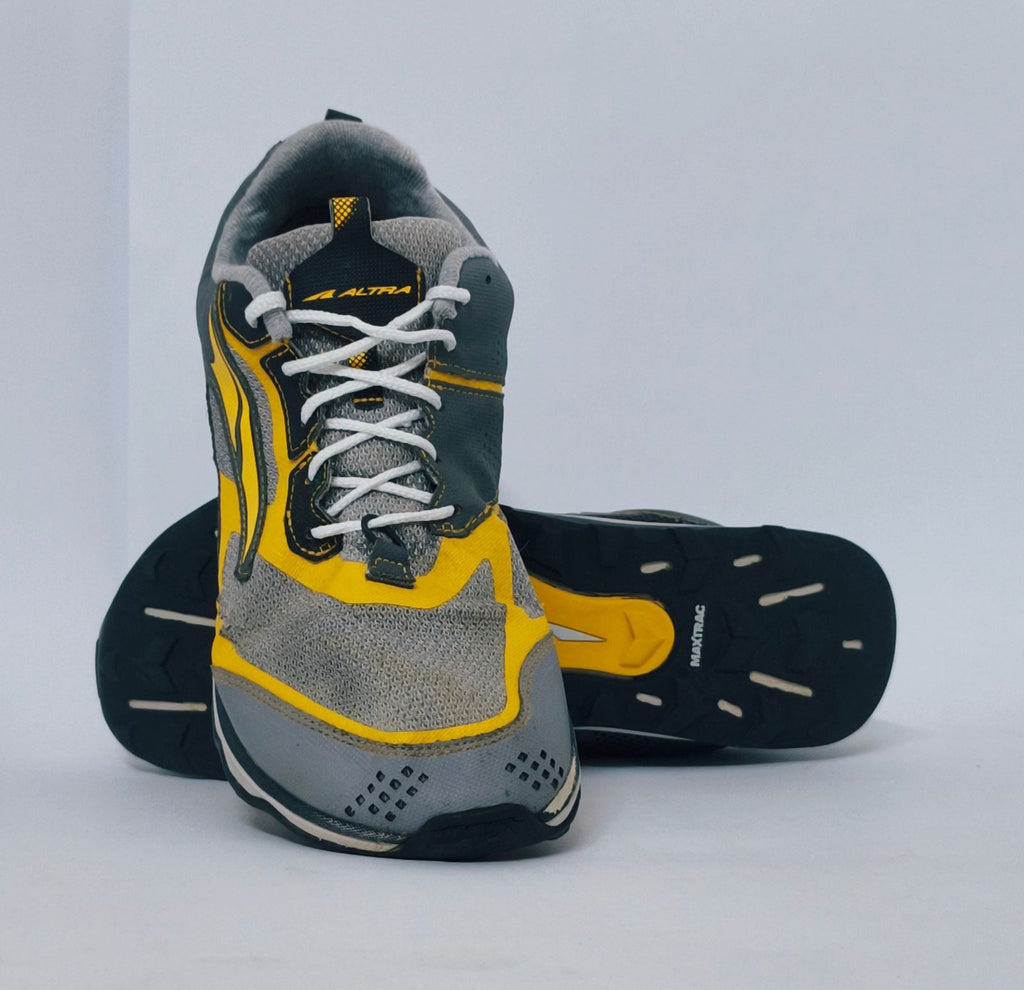 Grey and yellow athletic sneakers with breathable mesh upper and cushioned sole for running and casual wear