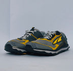 Grey and yellow athletic sneakers with breathable mesh upper and cushioned sole for running and casual wear