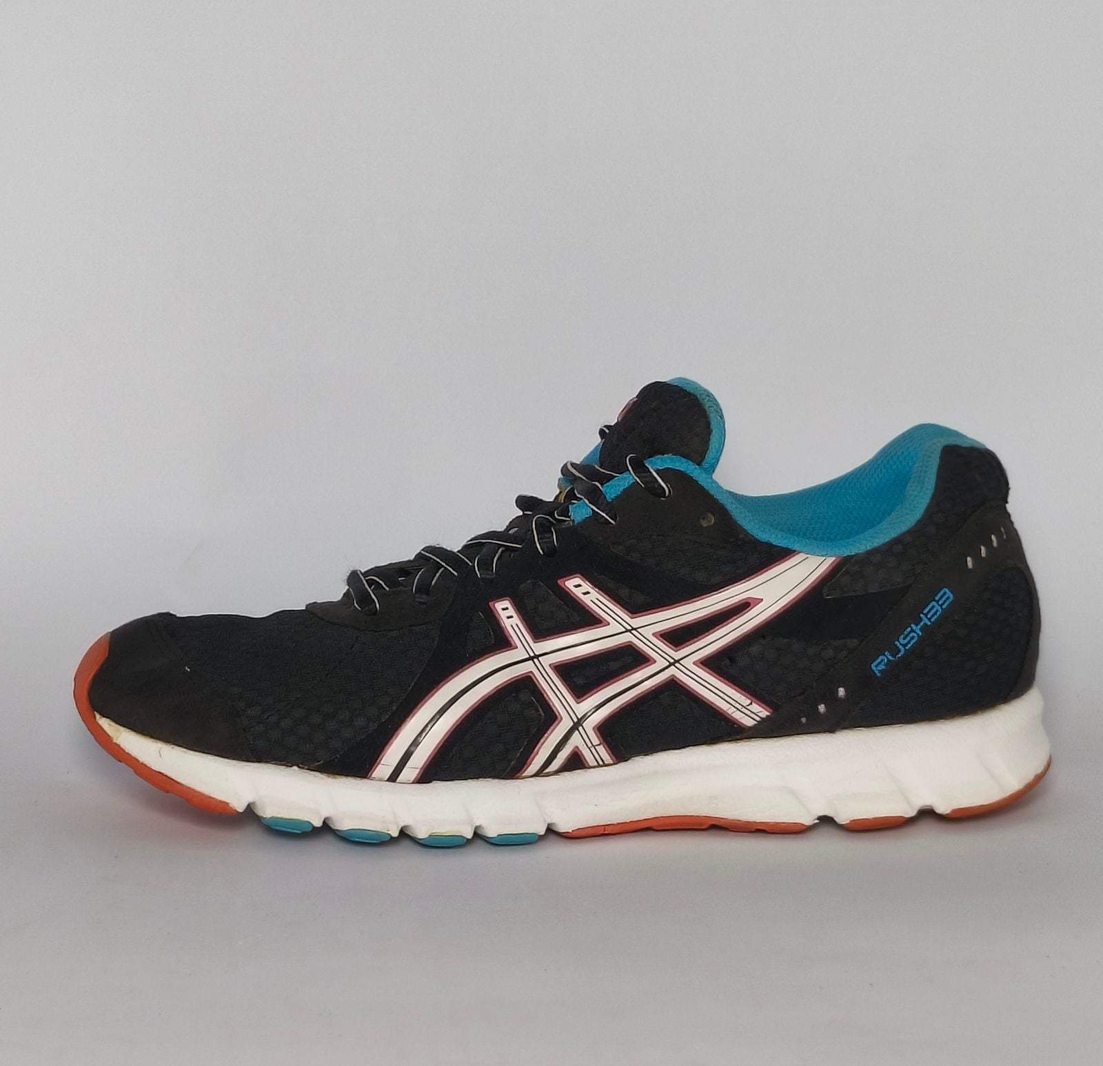 black ASICS GEL-Rush33 running shoe featuring teal interior lining and a white midsole with orange and blue outsole accents.
