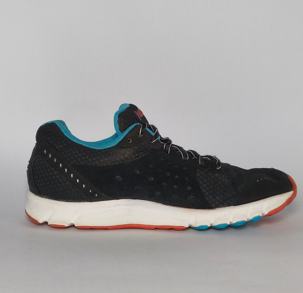 black ASICS GEL-Rush33 running shoe featuring teal interior lining and a white midsole with orange and blue outsole accents.