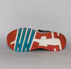 black ASICS GEL-Rush33 running shoe featuring teal interior lining and a white midsole with orange and blue outsole accents.