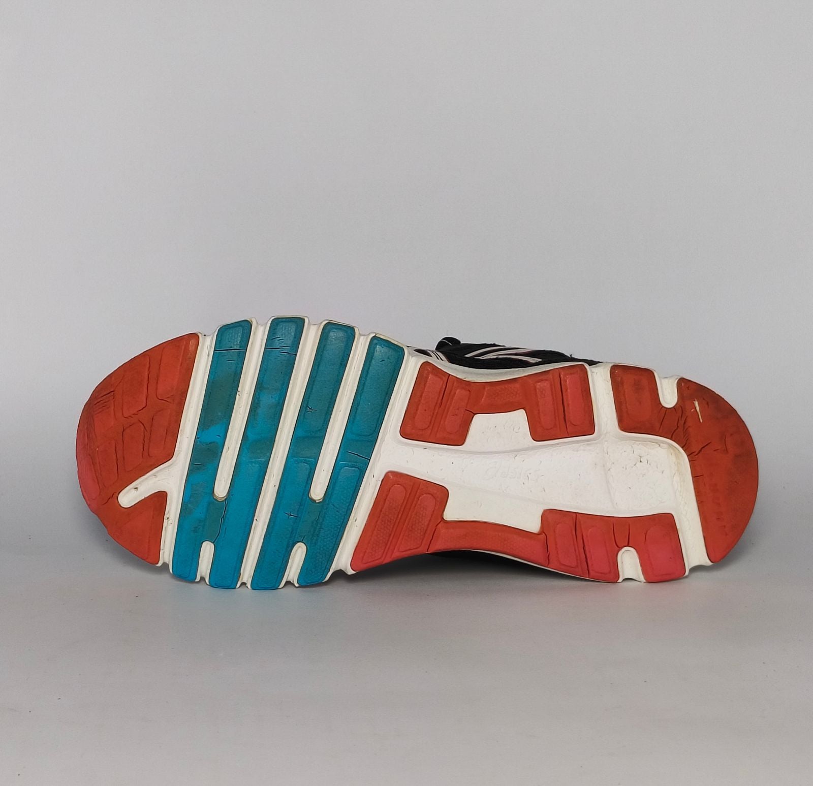 black ASICS GEL-Rush33 running shoe featuring teal interior lining and a white midsole with orange and blue outsole accents.