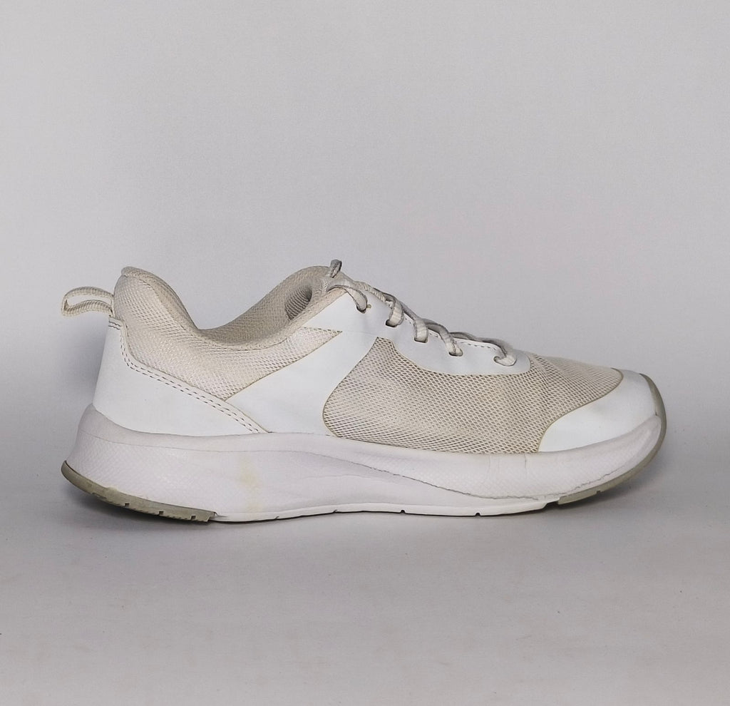 white and light grey athletic running shoe featuring silver accents and a thick white cushioned midsole.