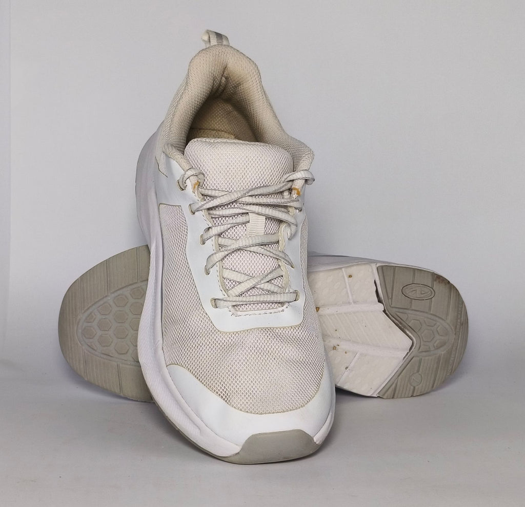 white and light grey athletic running shoe featuring silver accents and a thick white cushioned midsole.