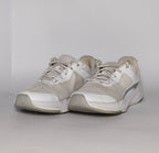 white and light grey athletic running shoe featuring silver accents and a thick white cushioned midsole.