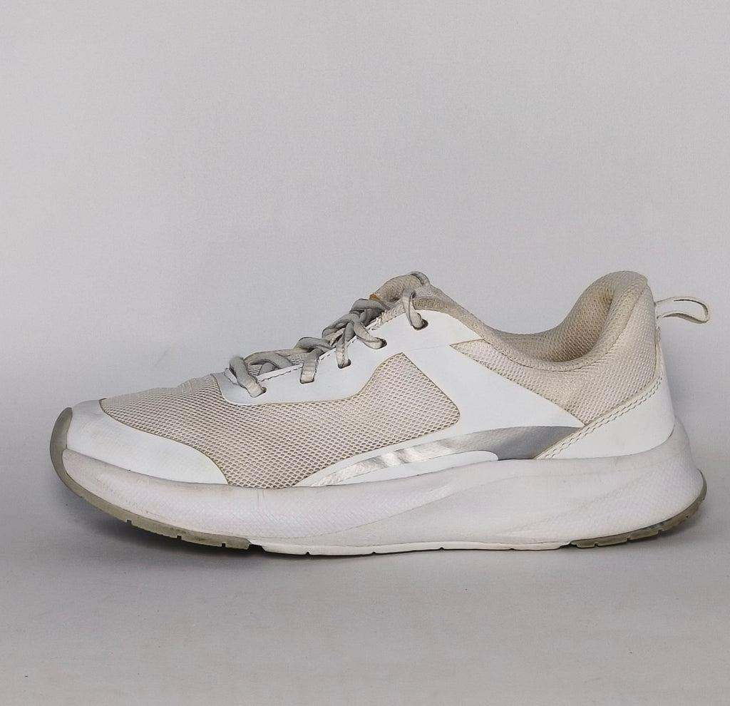 white and light grey athletic running shoe featuring silver accents and a thick white cushioned midsole.