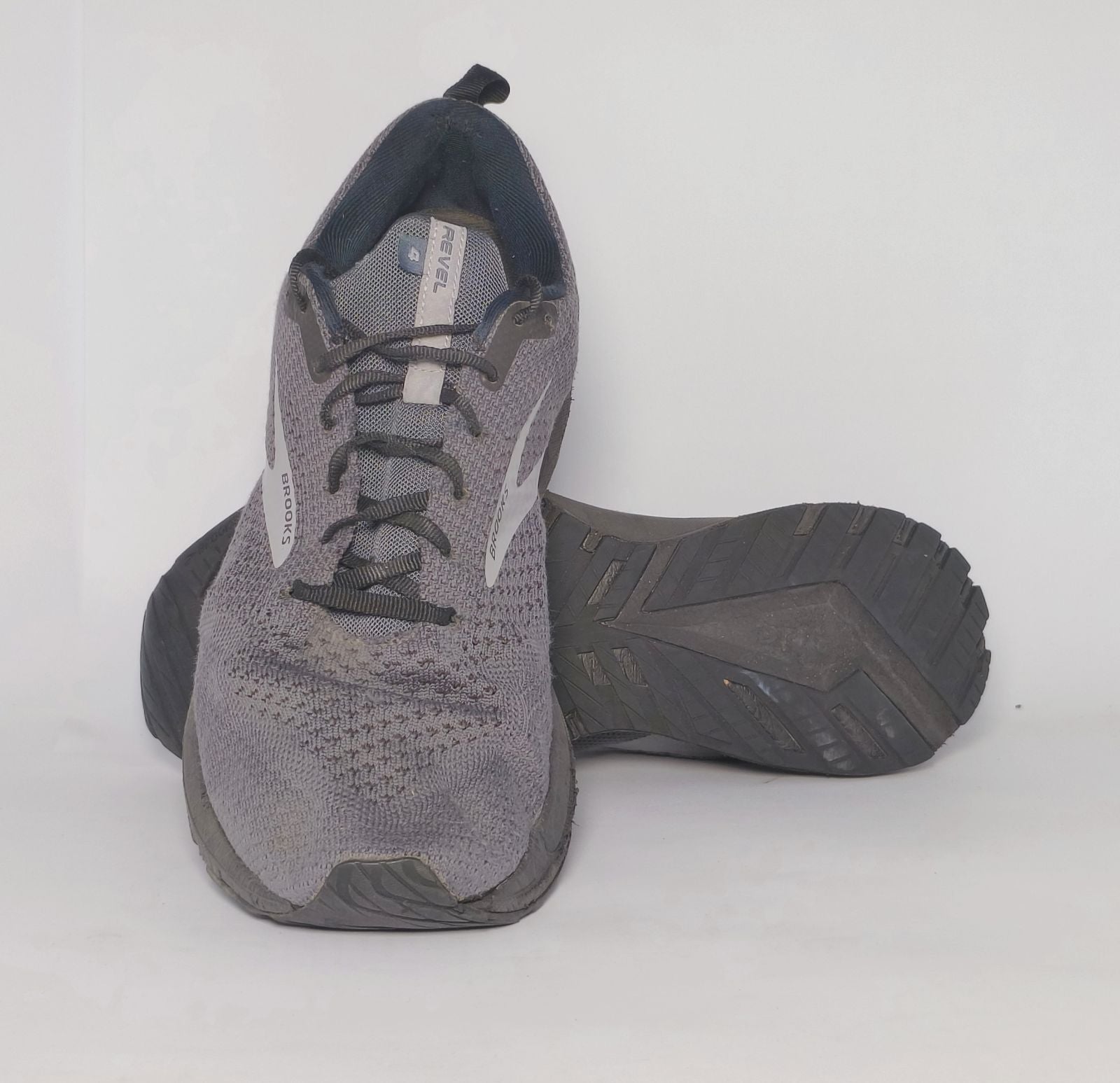 charcoal grey Brooks Revel running shoe featuring a silver logo and a black cushioned midsole.