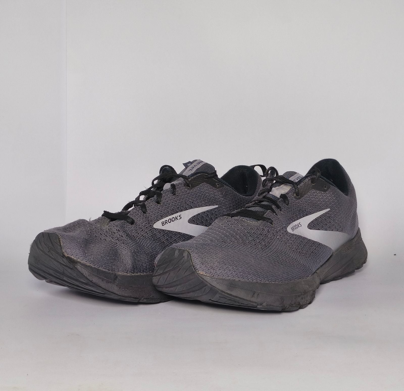 charcoal grey Brooks Revel running shoe featuring a silver logo and a black cushioned midsole.