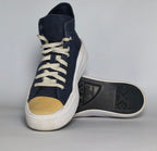 navy blue Converse Move platform high-top sneaker featuring a thick white midsole and a gold toe cap.