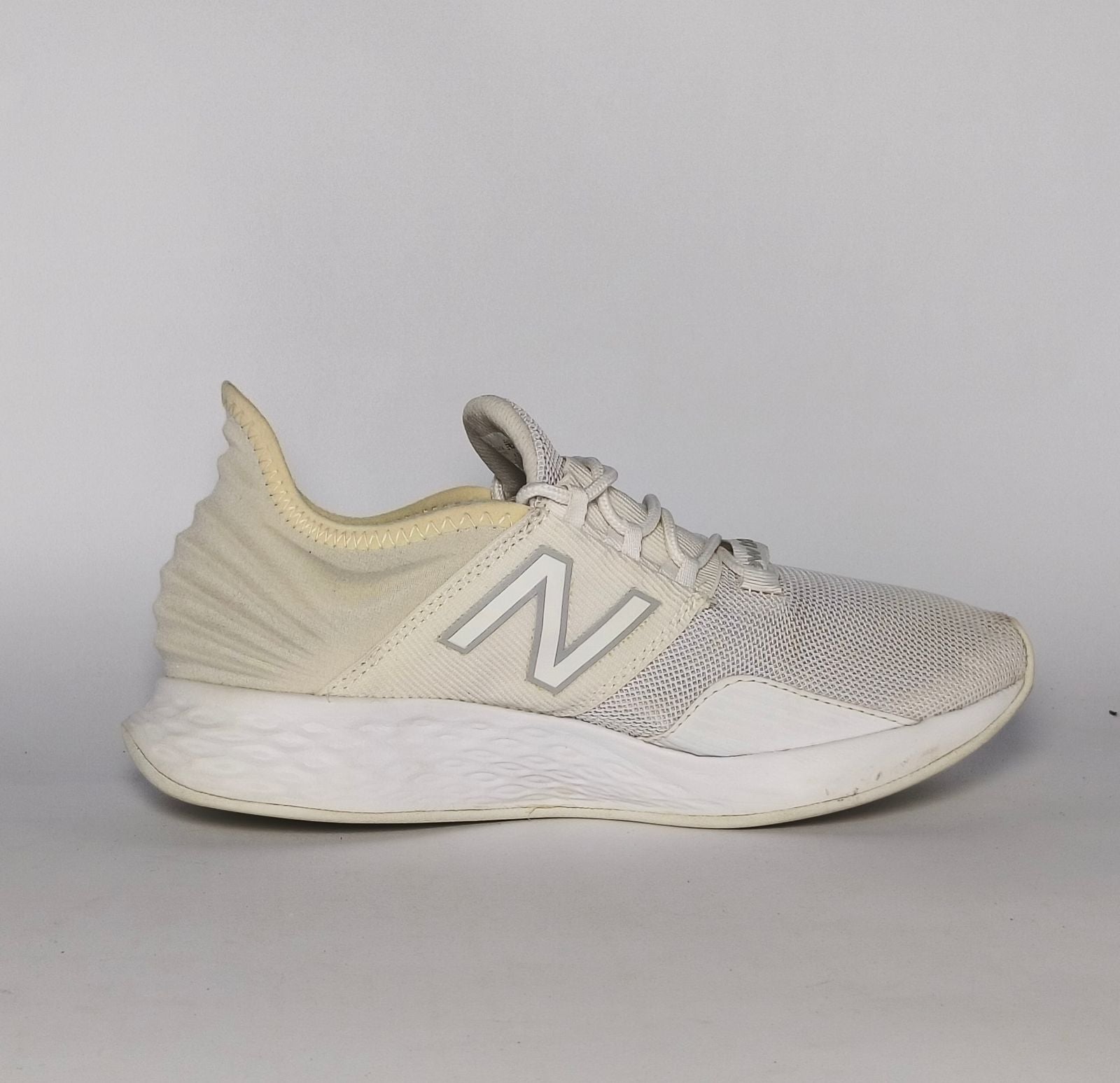 cream and light grey New Balance Fresh Foam Roav running shoe featuring a white textured midsole and a modern Ultra Heel design.