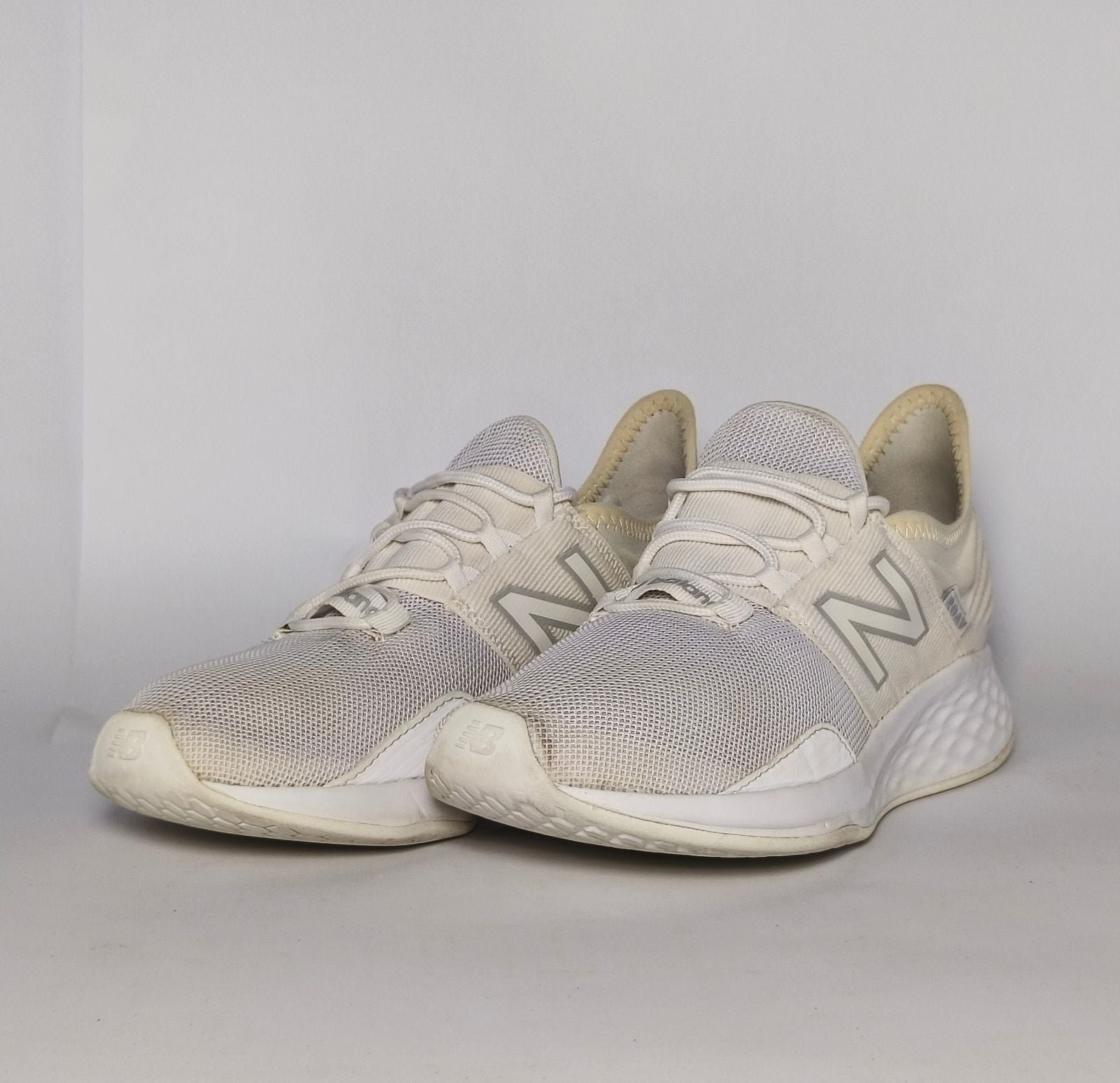 cream and light grey New Balance Fresh Foam Roav running shoe featuring a white textured midsole and a modern Ultra Heel design.