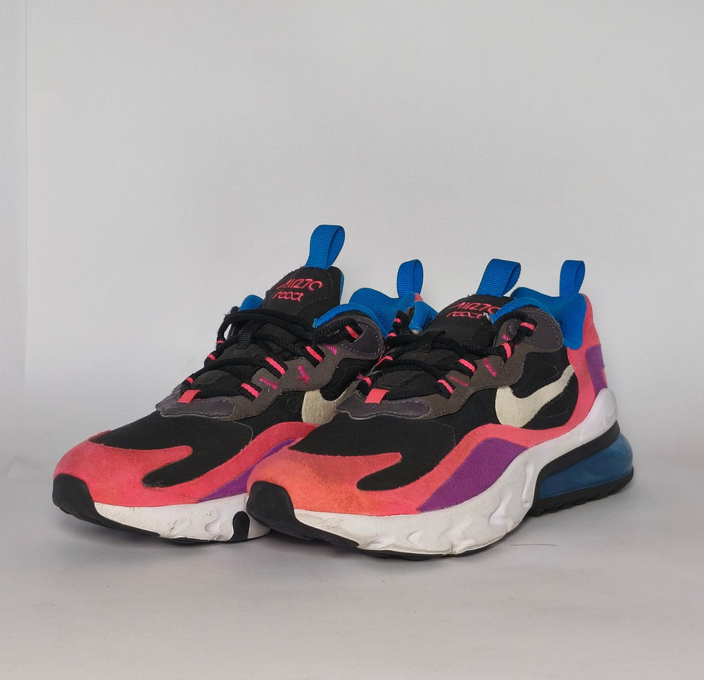 Nike Air Max 270 React sneaker featuring a pink and purple upper, a white React midsole, and a blue tinted Max Air heel unit.