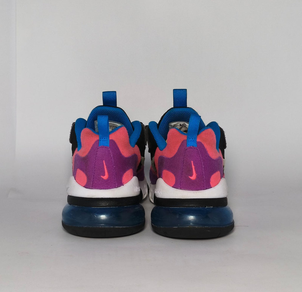 Nike Air Max 270 React sneaker featuring a pink and purple upper, a white React midsole, and a blue tinted Max Air heel unit.