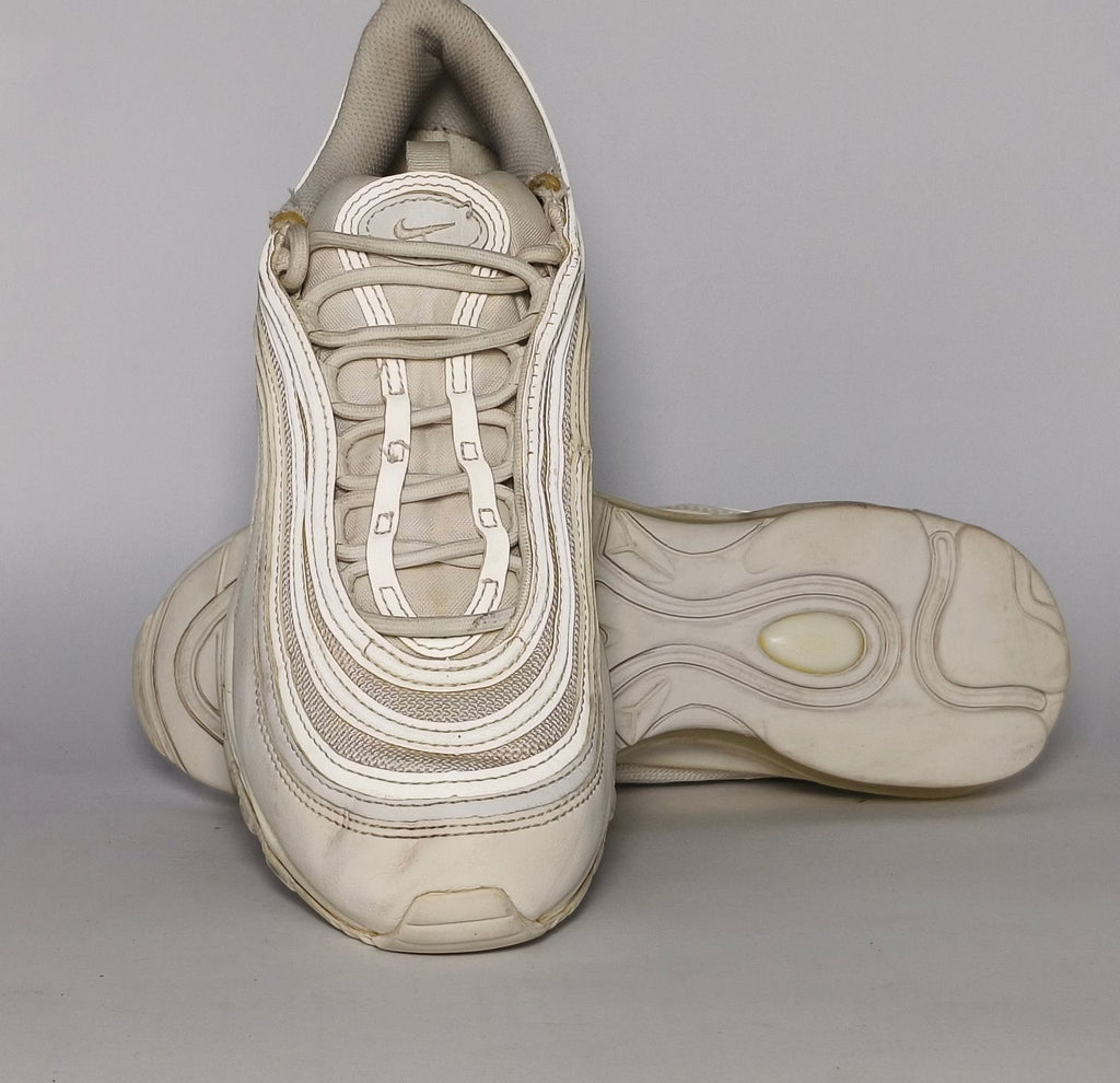light grey and cream Nike Air Max 97 sneaker featuring the iconic ripple design and a full-length visible Max Air cushioning unit.
