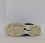 black Nike court sneaker featuring a white Swoosh and a thick white midsole with court-ready traction.