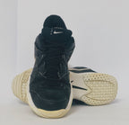 black Nike court sneaker featuring a white Swoosh and a thick white midsole with court-ready traction.