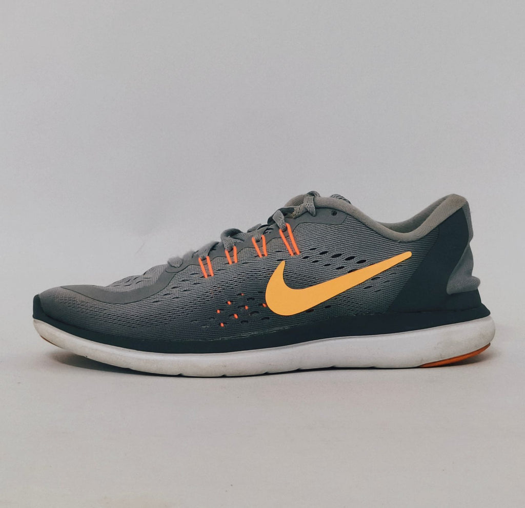 grey Nike Flex 2017 RN running shoe featuring an orange Swoosh and a flexible white midsole.