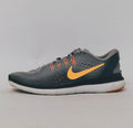 grey Nike Flex 2017 RN running shoe featuring an orange Swoosh and a flexible white midsole.