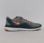 grey Nike Flex 2017 RN running shoe featuring an orange Swoosh and a flexible white midsole.