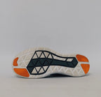 grey Nike Flex 2017 RN running shoe featuring an orange Swoosh and a flexible white midsole.