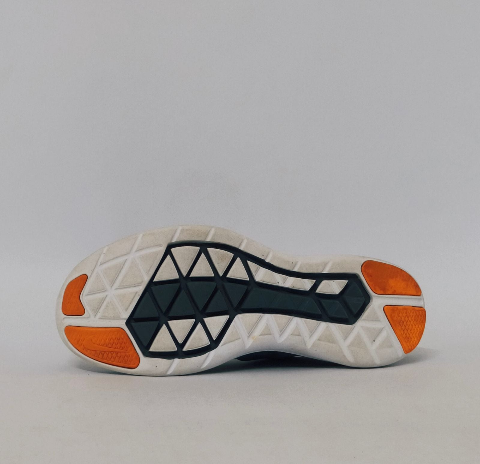 grey Nike Flex 2017 RN running shoe featuring an orange Swoosh and a flexible white midsole.