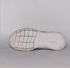 cream-colored Nike Flex Experience running shoe featuring a purple ankle collar, a black Swoosh, and a white flexible midsole.