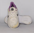 cream-colored Nike Flex Experience running shoe featuring a purple ankle collar, a black Swoosh, and a white flexible midsole.