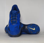 royal blue Nike Alpha Huarache baseball cleat featuring a white Swoosh and a specialized molded cleat outsole for field traction.