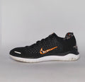 Nike Free RN 2018 running shoe featuring an orange "Just Do It" Swoosh and a white flexible midsole.