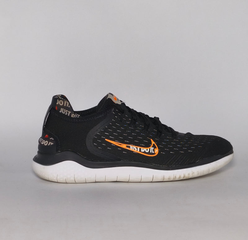 Nike Free RN 2018 running shoe featuring an orange "Just Do It" Swoosh and a white flexible midsole.
