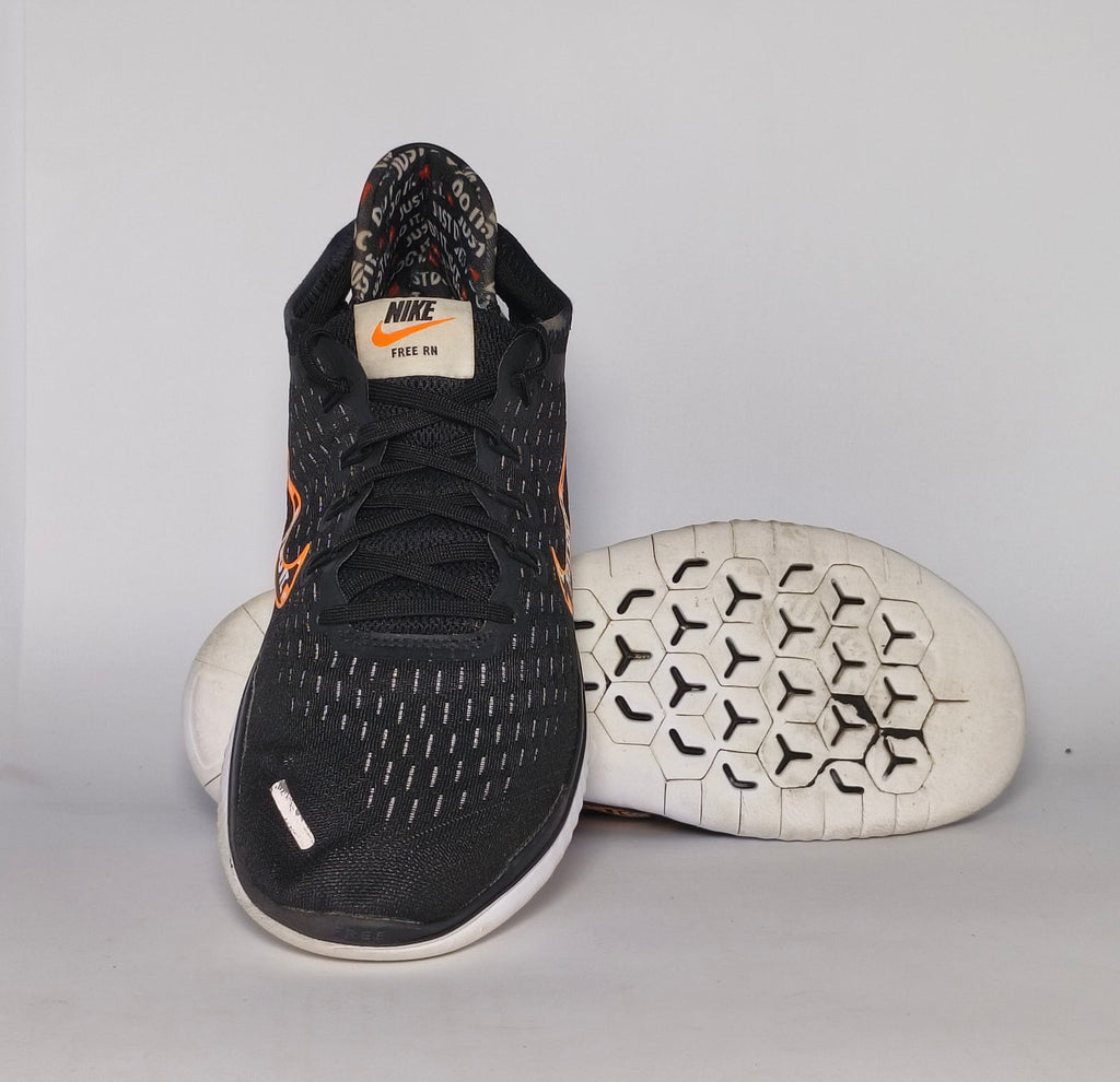 Nike Free RN 2018 running shoe featuring an orange "Just Do It" Swoosh and a white flexible midsole.