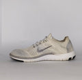 cream and grey Nike Free RN Flyknit running shoe featuring a white flexible midsole and a minimalist textured design.