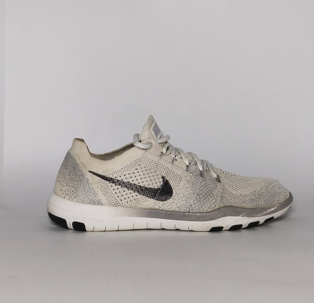 cream and grey Nike Free RN Flyknit running shoe featuring a white flexible midsole and a minimalist textured design.