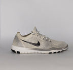 cream and grey Nike Free RN Flyknit running shoe featuring a white flexible midsole and a minimalist textured design.