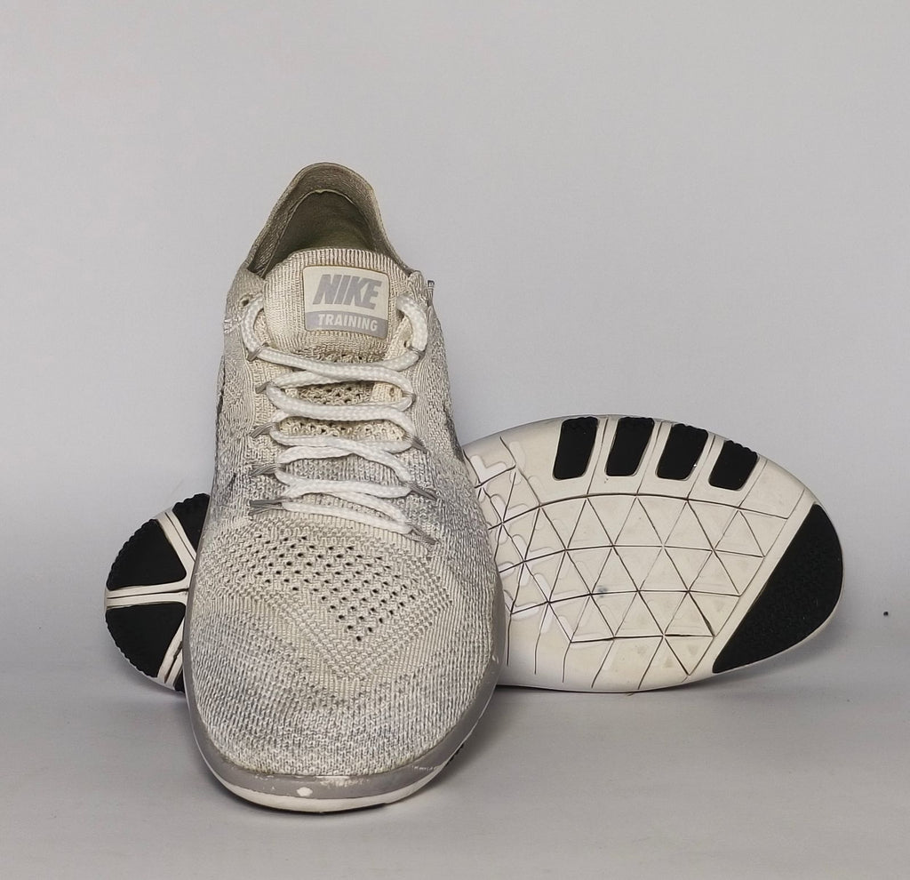 cream and grey Nike Free RN Flyknit running shoe featuring a white flexible midsole and a minimalist textured design.
