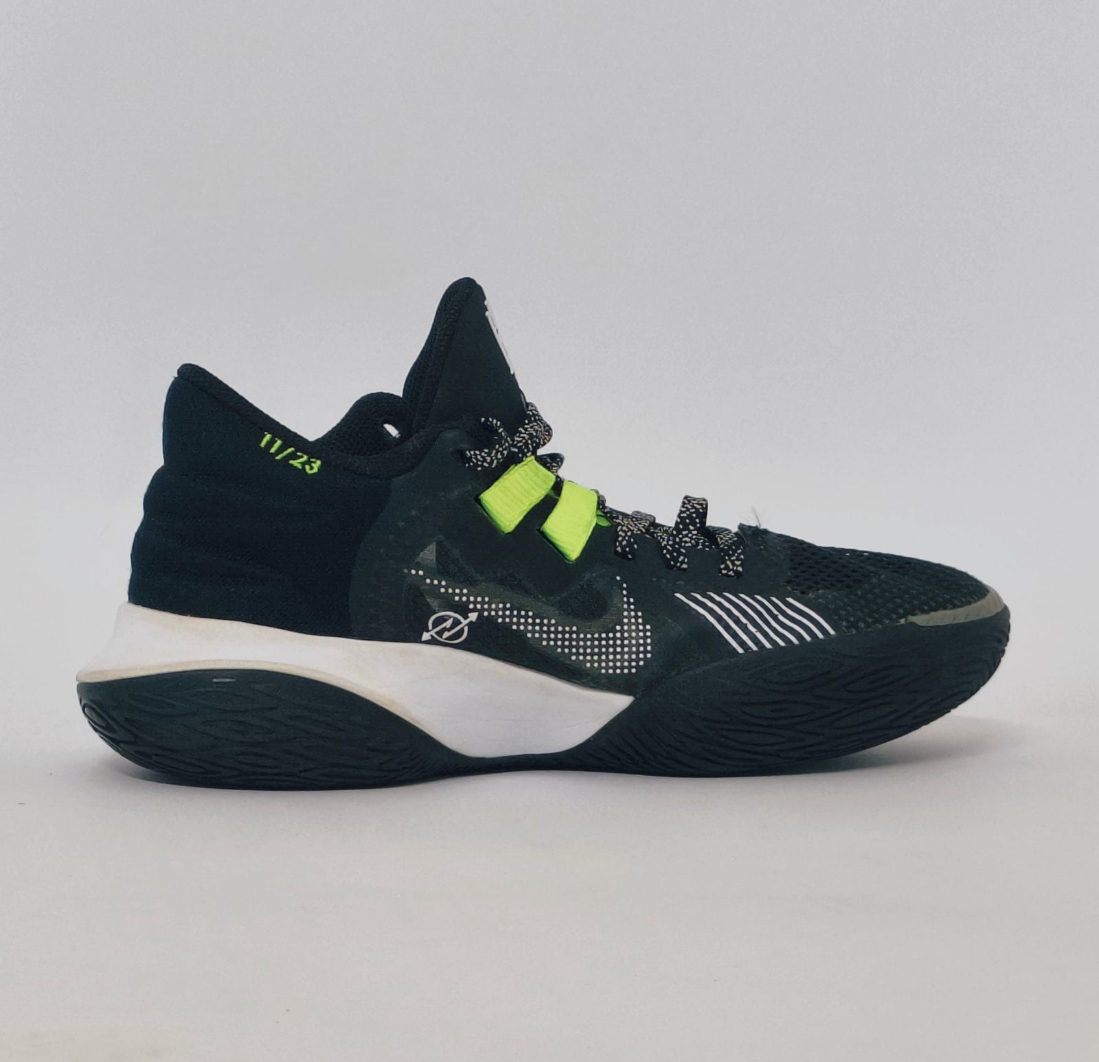 Nike Kyrie Flytrap basketball shoe featuring lime green accents, a white midsole, and a high-traction black outsole.