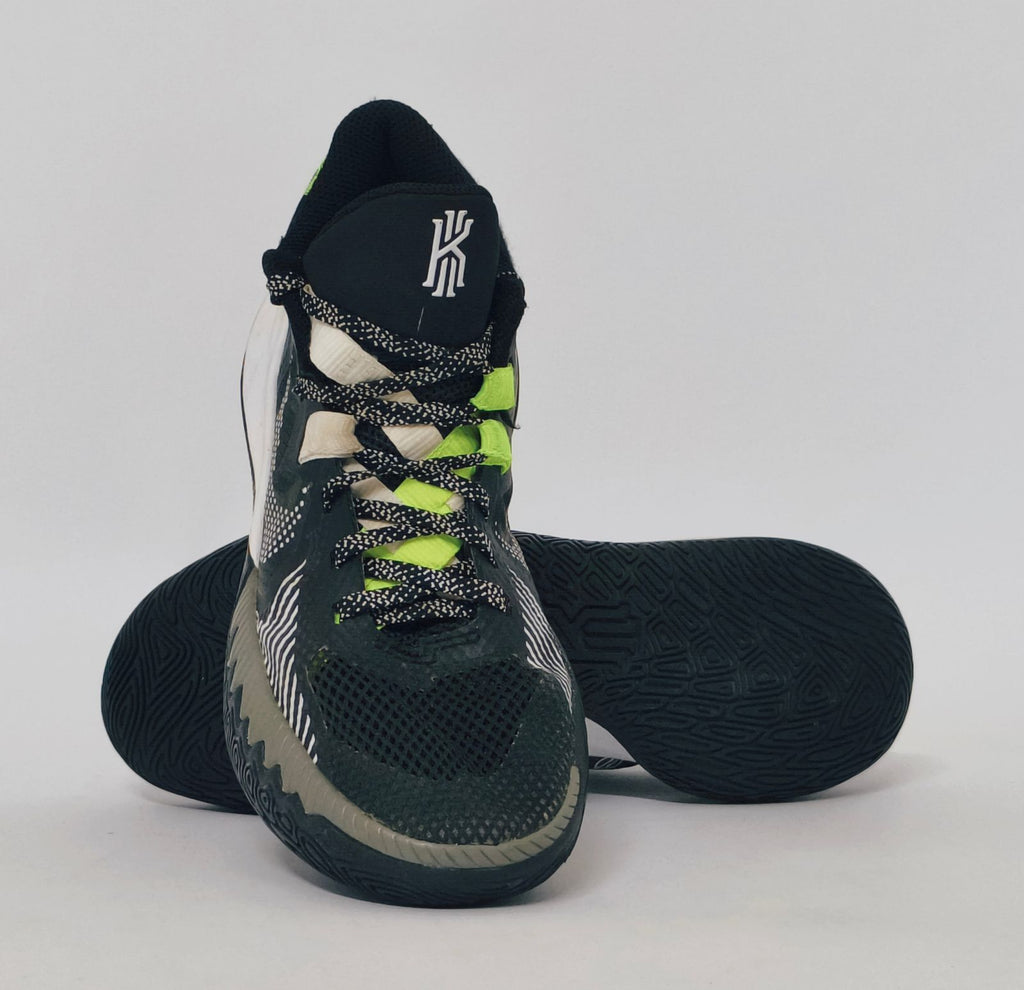 Nike Kyrie Flytrap basketball shoe featuring lime green accents, a white midsole, and a high-traction black outsole.