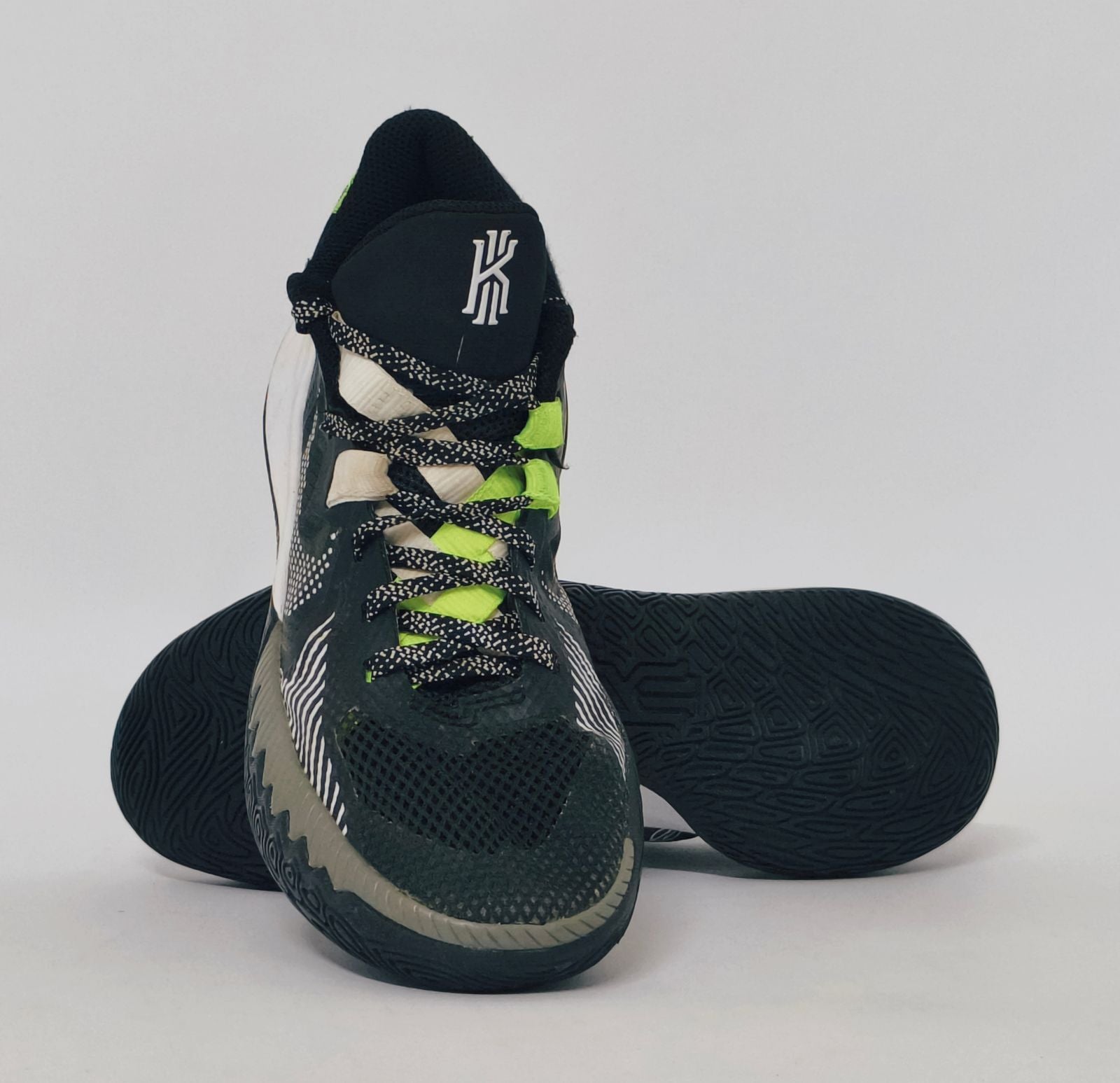 Nike Kyrie Flytrap basketball shoe featuring lime green accents, a white midsole, and a high-traction black outsole.