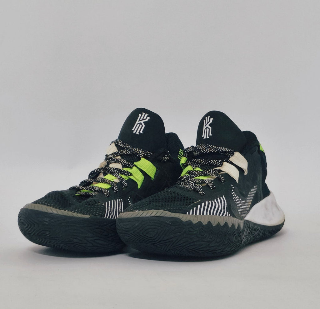 Nike Kyrie Flytrap basketball shoe featuring lime green accents, a white midsole, and a high-traction black outsole.