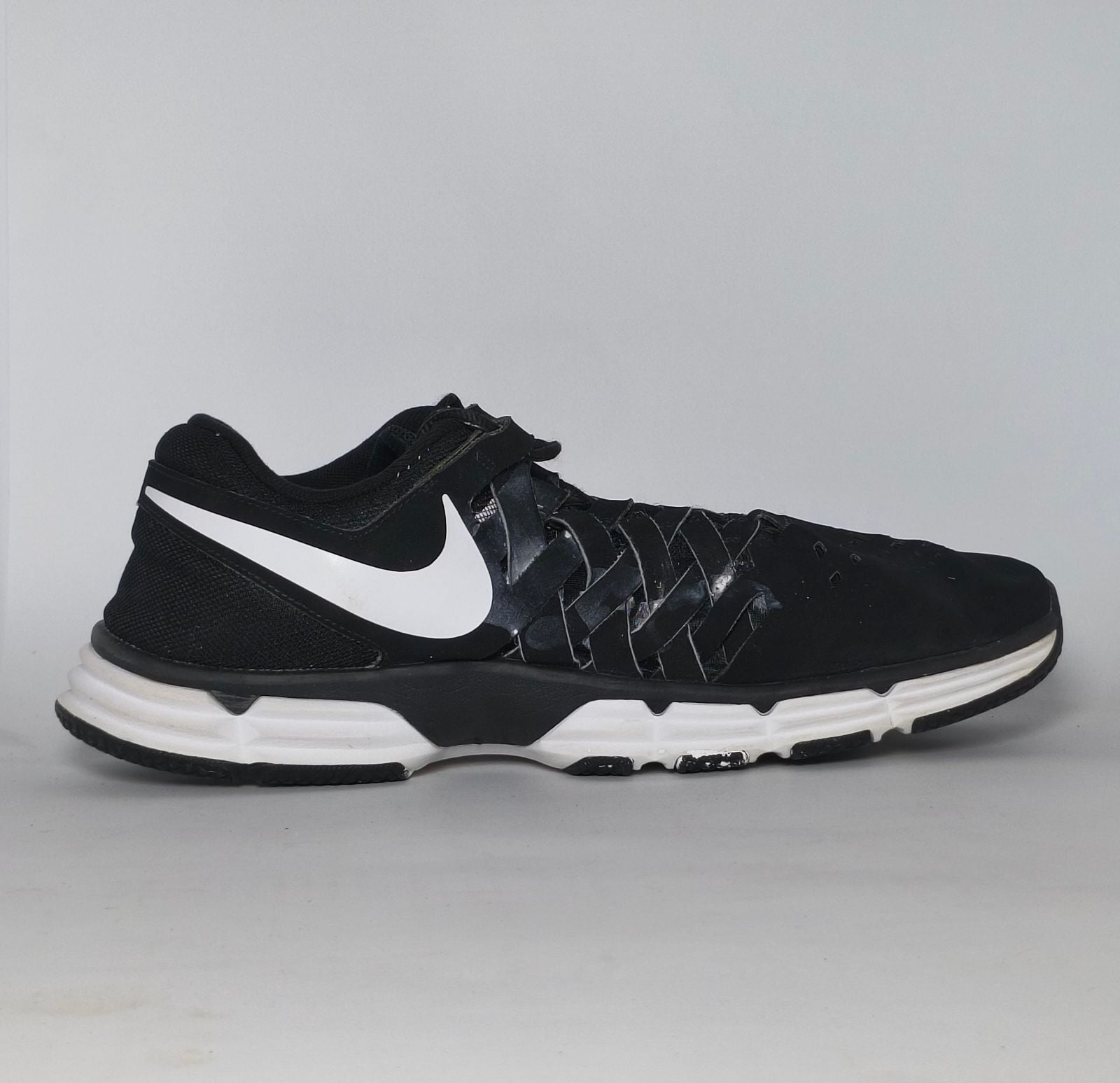 black Nike Lunar Fingertrap TR training shoe featuring a white Swoosh and a white Lunarlon midsole.