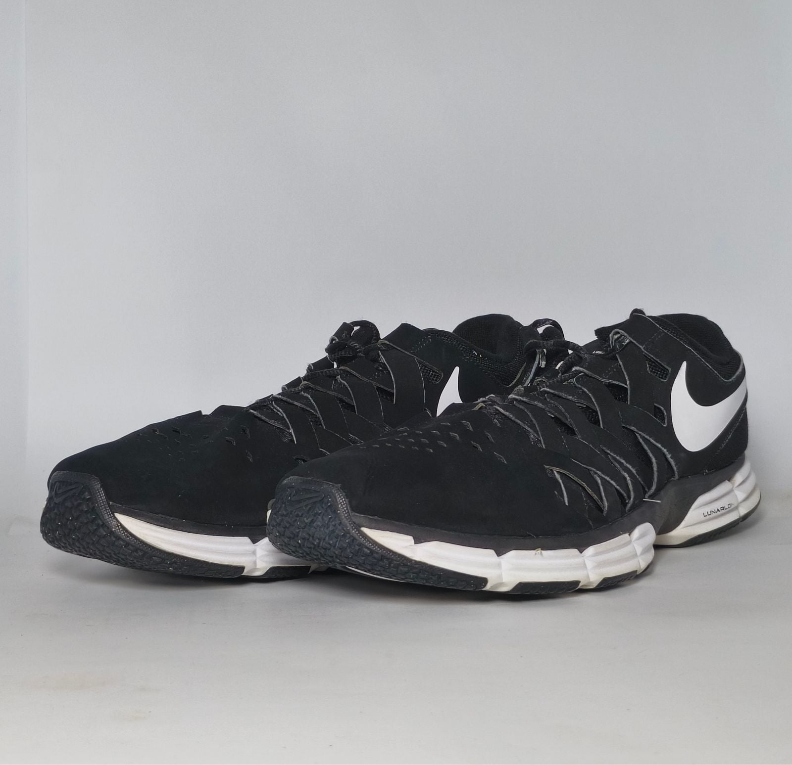black Nike Lunar Fingertrap TR training shoe featuring a white Swoosh and a white Lunarlon midsole.