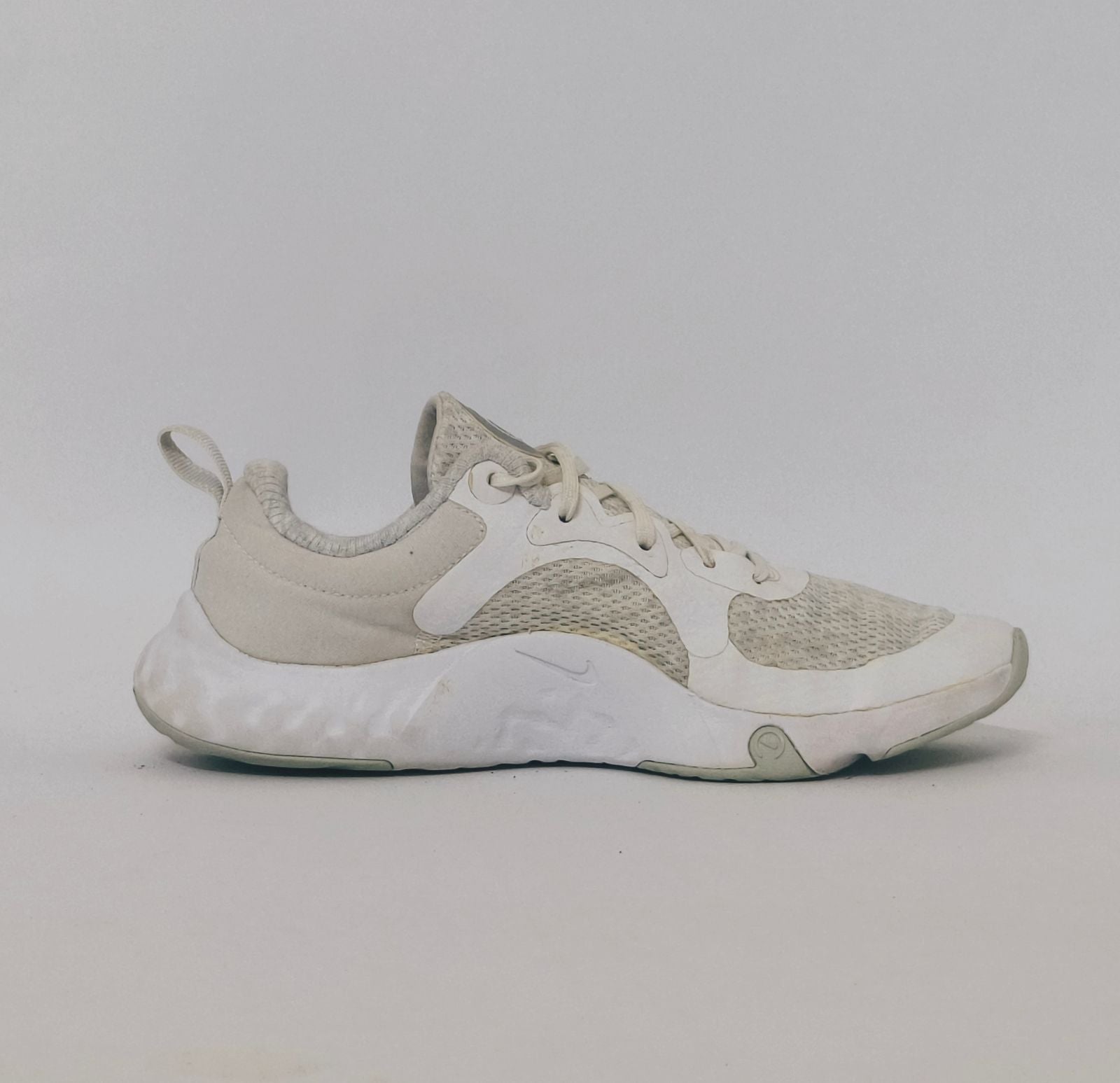 white Nike Renew In-Season TR 10 training shoes featuring a breathable mesh upper and silver Nike Swoosh.