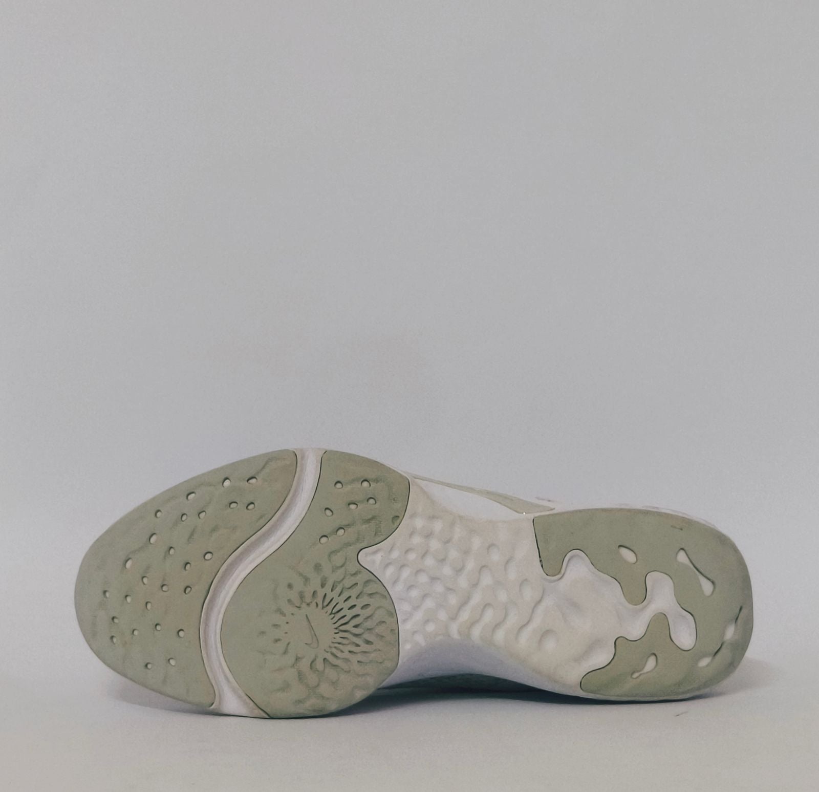 white Nike Renew In-Season TR 10 training shoes featuring a breathable mesh upper and silver Nike Swoosh.