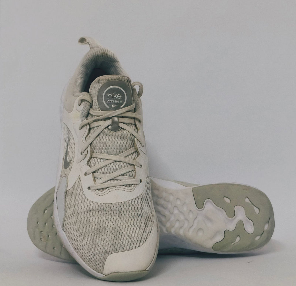 white Nike Renew In-Season TR 10 training shoes featuring a breathable mesh upper and silver Nike Swoosh.