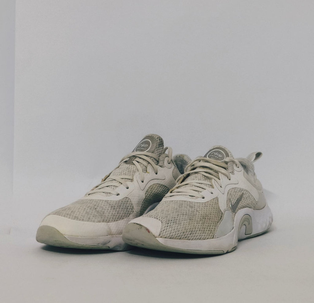 white Nike Renew In-Season TR 10 training shoes featuring a breathable mesh upper and silver Nike Swoosh.