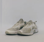 white Nike Renew In-Season TR 10 training shoes featuring a breathable mesh upper and silver Nike Swoosh.